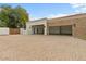 Three-car garage with stone accents and open bays, offering ample parking and storage at 2121 N Orchard --, Mesa, AZ 85213