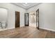 Living room featuring wood floors, an open doorway, and access to a bathroom at 2121 N Orchard --, Mesa, AZ 85213