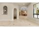 Spacious living room featuring tile floors with an arched entryway into the kitchen area at 2121 N Orchard --, Mesa, AZ 85213