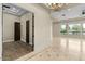 Bright living room with large windows, marble floors, and recessed lighting create an open, inviting space at 2121 N Orchard --, Mesa, AZ 85213