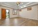 Bright living room with wood floors, three windows with wood shutters and a glass door to the backyard at 2121 N Orchard --, Mesa, AZ 85213