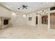 Open living room featuring tile floors, stone fireplace, and a decorative ceiling with dark wood door at 2121 N Orchard --, Mesa, AZ 85213