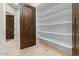 Walk-in pantry with custom shelving providing ample storage space at 2121 N Orchard --, Mesa, AZ 85213