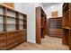 Organized walk-in closet with custom wood shelves, cabinets, and drawers for ample storage at 2121 N Orchard --, Mesa, AZ 85213