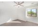 Bright bedroom with ceiling fan and neutral carpeting at 35852 N 10Th St, Phoenix, AZ 85086