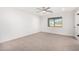 Well-lit bedroom with ceiling fan and neutral carpeting at 35852 N 10Th St, Phoenix, AZ 85086