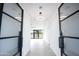 Bright hallway with modern light fixture and glass doors at 35852 N 10Th St, Phoenix, AZ 85086