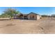 Back of tan house with covered patio, large yard at 35852 N 10Th St, Phoenix, AZ 85086