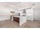 Spacious kitchen with white cabinets, an island, and stainless steel appliances at 35852 N 10Th St, Phoenix, AZ 85086