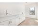 Bright laundry room with white cabinets and countertop at 35852 N 10Th St, Phoenix, AZ 85086