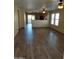 Bright and airy living room with wood-look flooring at 40160 W Mary Lou Dr, Maricopa, AZ 85138