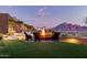 Backyard with firepit and seating area, offering stunning mountain views at 4060 E Lamar Rd, Paradise Valley, AZ 85253