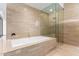 Bathroom with soaking tub and glass shower at 4060 E Lamar Rd, Paradise Valley, AZ 85253