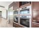 Modern kitchen with built in oven and stainless steel refrigerator at 4060 E Lamar Rd, Paradise Valley, AZ 85253