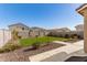 This backyard boasts lush green grass, desert landscaping, and stamped concrete walkways at 4488 W Charlie Dr, San Tan Valley, AZ 85144