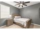 Cozy bedroom with a neutral color scheme, a ceiling fan, and a bedside table with a lamp at 4488 W Charlie Dr, San Tan Valley, AZ 85144