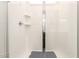 Bright shower with glass doors, white tile, and built-in shelves for toiletries at 4488 W Charlie Dr, San Tan Valley, AZ 85144