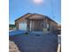 Tan house with a covered porch, white garage door, and gravel driveway at 5647 E Calle Pitaya --, Guadalupe, AZ 85283