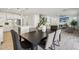 Modern dining room with a dark wood table and seating for six, near kitchen and living areas at 634 E Deer Creek Rd, Phoenix, AZ 85048