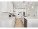 Modern kitchen with white cabinets, stainless steel appliances, and a large island at 634 E Deer Creek Rd, Phoenix, AZ 85048