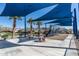 Community playground with shade structures, tables, chairs, and a climbing dome, surrounded by grass and palm trees at 634 E Deer Creek Rd, Phoenix, AZ 85048