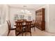 Dining area with wood hutch and table with four chairs at 9510 E Jadecrest Dr, Sun Lakes, AZ 85248