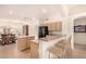 Kitchen with island, breakfast bar, and light wood cabinets at 9510 E Jadecrest Dr, Sun Lakes, AZ 85248