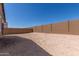 Large, open backyard showcasing the neutral landscaping and a tall block wall providing privacy and security at 18544 E Dario Rd, Gold Canyon, AZ 85118