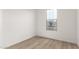 Bedroom with wood flooring and a large window providing natural light at 18544 E Dario Rd, Gold Canyon, AZ 85118