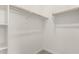 This walk-in closet has white walls, wooden rods and wire shelving at 18544 E Dario Rd, Gold Canyon, AZ 85118