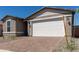Garage view with brick paver driveway, desert landscaping and an eye-catching exterior color scheme at 18544 E Dario Rd, Gold Canyon, AZ 85118
