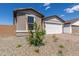 A welcoming exterior view of this home highlighting the desert landscaping, garage and neutral color palette at 18544 E Dario Rd, Gold Canyon, AZ 85118