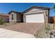 A well maintained exterior, features a brick driveway, desert landscaping, and a spacious two-car garage at 18544 E Dario Rd, Gold Canyon, AZ 85118
