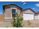 Charming exterior with desert landscaping, a two-car garage and warm colors that enhance curb appeal at 18544 E Dario Rd, Gold Canyon, AZ 85118