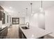 Open-concept kitchen and living area with an island with stainless steel sink and modern pendant lights at 18544 E Dario Rd, Gold Canyon, AZ 85118