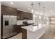 Modern kitchen boasts stainless steel appliances, white countertops and island with pendant lighting at 18544 E Dario Rd, Gold Canyon, AZ 85118