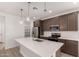 Contemporary kitchen features quartz countertops, a large island, and stainless steel appliances at 18544 E Dario Rd, Gold Canyon, AZ 85118