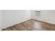 Bright bedroom with vinyl floors and natural light streaming through a window with blinds at 41735 N 260Th Ave, Morristown, AZ 85342