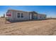 Charming single-story home featuring a light gray exterior and well-maintained desert landscaping at 41735 N 260Th Ave, Morristown, AZ 85342