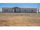 Front exterior of grey home with desert landscaping surrounding property at 41735 N 260Th Ave, Morristown, AZ 85342