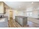 Modern kitchen with a center island that connects to an open living space for entertaining at 41735 N 260Th Ave, Morristown, AZ 85342