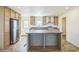 Modern kitchen featuring stainless steel appliances, light-colored cabinets, and a center island at 41735 N 260Th Ave, Morristown, AZ 85342