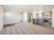 Bright open-concept living room seamlessly flows into a modern kitchen with stainless steel appliances at 41735 N 260Th Ave, Morristown, AZ 85342
