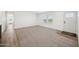 Inviting carpeted living room features a large window, creating a bright and airy atmosphere at 41735 N 260Th Ave, Morristown, AZ 85342