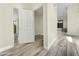 Hallway featuring wood-look flooring, white trim, and an open doorway, creating a bright and welcoming entrance at 5016 E Marconi Ave, Scottsdale, AZ 85254