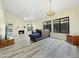 Inviting living room features a fireplace, light-colored walls, wood-look tile floors, and large windows to the backyard at 5016 E Marconi Ave, Scottsdale, AZ 85254