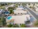 Aerial view of neighborhood with a home featuring a pool at 8549 W El Caminito Dr, Peoria, AZ 85345