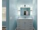 Bathroom with white vanity, granite countertop, and floating shelves at 8549 W El Caminito Dr, Peoria, AZ 85345