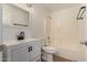 Bathroom with a single sink vanity, tiled shower-tub, and toilet at 8549 W El Caminito Dr, Peoria, AZ 85345