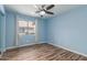 Bedroom with light blue walls, ceiling fan, and window coverings at 8549 W El Caminito Dr, Peoria, AZ 85345